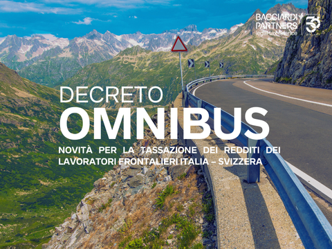 strada di montagna con in lontananza cime innevate, logo bacciardi Partners e il testo in grafica Decreto Omnibus novità per la tassazione dei redditi dei lavoratori frontalieri italia svizzera